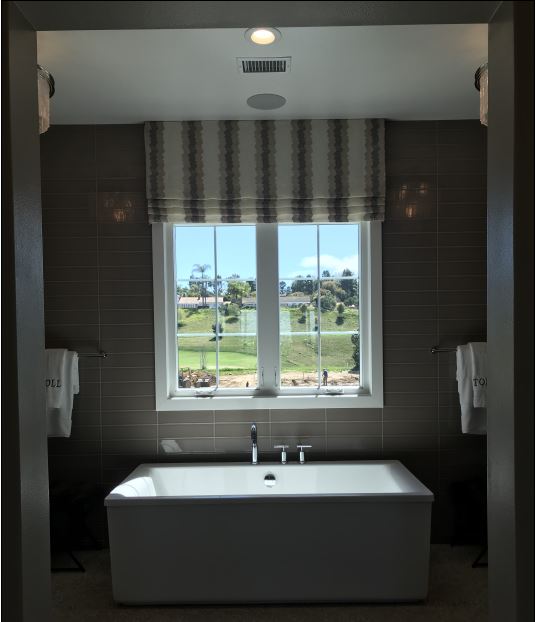 Bathroom with a bathtub and rectangular glass windows